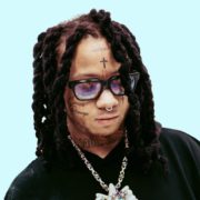 Trippie Redd Unveils His Eccentric Side with a New Selfie Featuring a Striking Religious Mask Trippie Redd, the maverick in the world of hip-hop, has never shied away from showcasing his unique style and personality. He once again left his fans intrigued when he took to Twitter to share a brand-new selfie. In this captivating snapshot, he dons a remarkable mask that centers around an eye-catching image of Jesus on the cross, shimmering in metallic silver. Adding to the visual spectacle, he wears an enigmatic grin, revealing the intricate jewelry adorning his mouth.